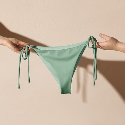 Pastel green recycled string bikini bottom with pastel lining is sizes 2XS-6XL