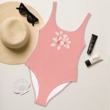 Blush pink one-piece swimsuit with Frangipani blossoms.