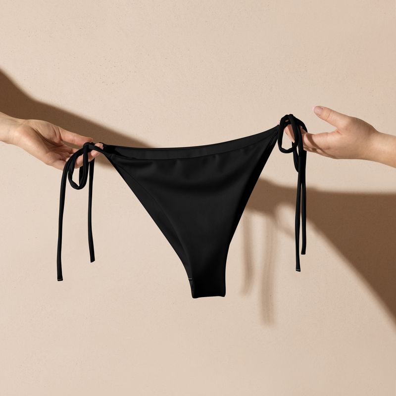 Black string bikini bottoms have black lining. Flattering fit.