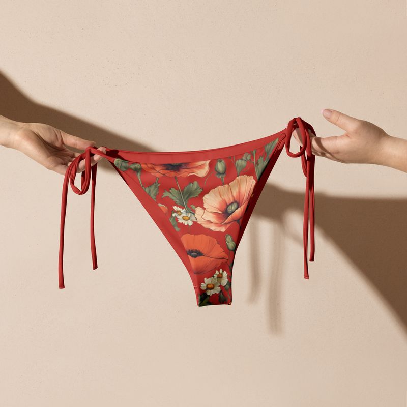 Orange-red string bikini bottom features stunning poppy flowers.