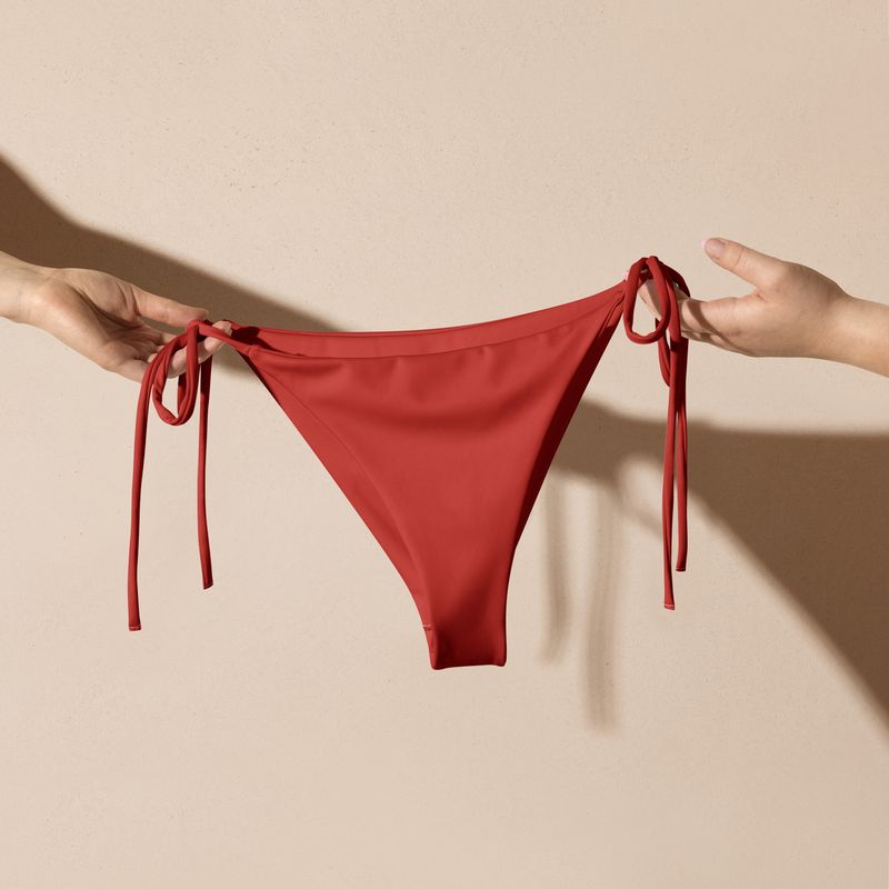 Orange red string bikini bottoms.