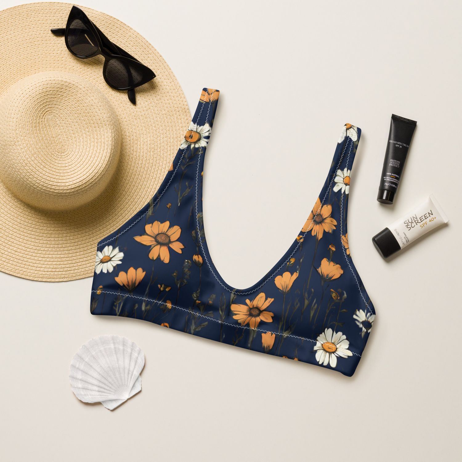 The navy blue padded bikini top with retro wildflowers has a sporty fit. Removable padding.