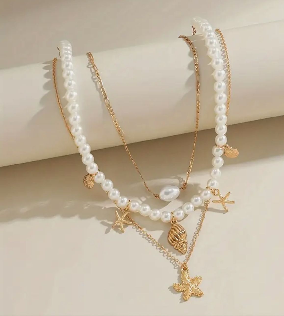 The Ocean Heirloom Set — A Trio of Handcrafted Vintage-Style Necklaces Adorned with Starfish and Conch Charms, Finished with Delicate Beads and Flowing Tassels for a Touch of Seaside Luxury The Ocean Heirloom Set — A Trio of Handcrafted Vintage-Style Necklaces Adorned with Starfish and Conch Charms, Finished with Delicate Beads and Flowing Tassels for a Touch of Seaside Luxury