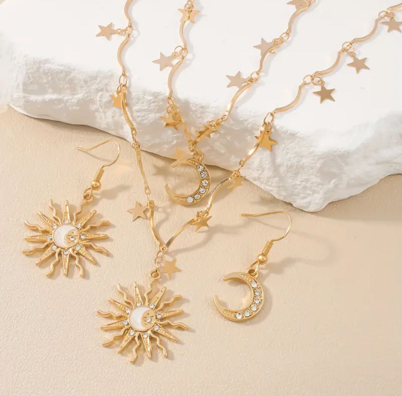 The Sol & Luna Set — A Four-Piece Celestial Jewelry Collection featuring Asymmetrical Sun and Moon Pendants with Star-Kissed Chains. Designed for the Modern Goddess The Sol & Luna Set — A Four-Piece Celestial Jewelry Collection featuring Asymmetrical Sun and Moon Pendants with Star-Kissed Chains. Designed for the Modern Goddess