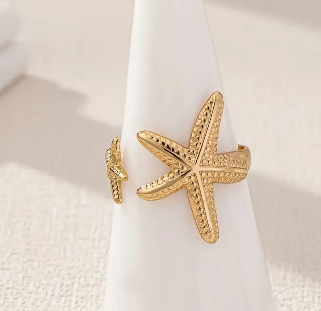Golden Starfish Ring — A 14K Gold-Plated Statement Piece Inspired by the Sea. This Elegant, Beach-Themed Ring Captures Effortless Glamour and Everyday Sophistication Golden Starfish Ring — A 14K Gold-Plated Statement Piece Inspired by the Sea. This Elegant, Beach-Themed Ring Captures Effortless Glamour and Everyday Sophistication