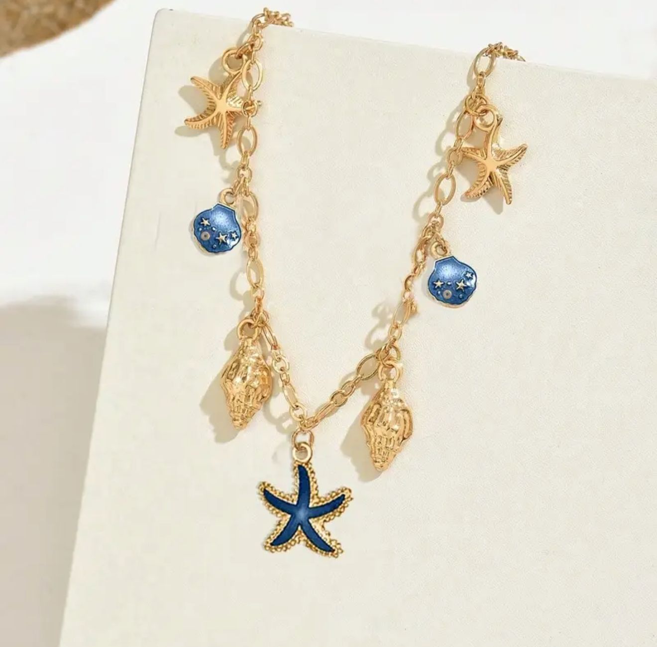Ocean Symphony Necklace — A Bohemian-Inspired Masterpiece Adorned with Starfish, Shell, and Turtle Charms. this Statement Piece Captures the Spirit of Seaside Elegance and Free Flowing Summer Glamour Ocean Symphony Necklace — A Bohemian-Inspired Masterpiece Adorned with Starfish, Shell, and Turtle Charms. this Statement Piece Captures the Spirit of Seaside Elegance and Free Flowing Summer Glamour