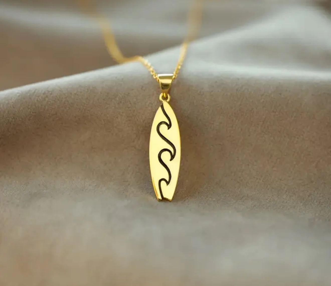 The Sea Wanderer Necklace — A Stainless Steel Surfboard Pendant with a Copper Accent Symbolizing Strength and Flow. Unplated and Timeless, It Reflects the Balance Between Freedom and Serenity The Sea Wanderer Necklace — A Stainless Steel Surfboard Pendant with a Copper Accent Symbolizing Strength and Flow. Unplated and Timeless, It Reflects the Balance Between Freedom and Serenity