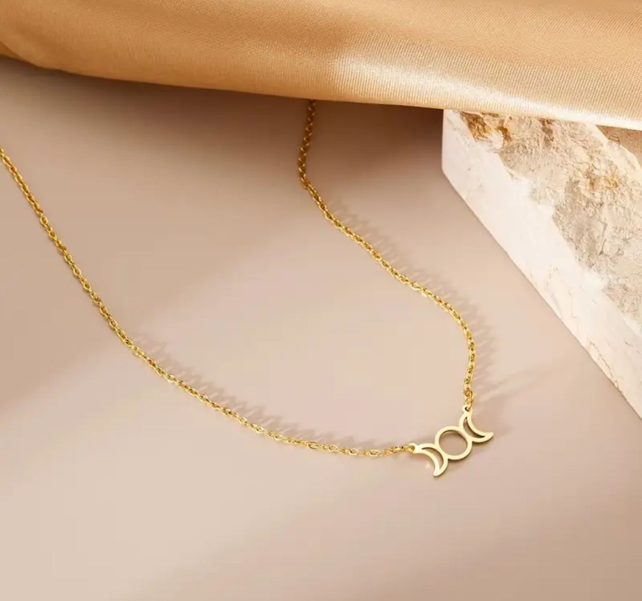 Lunar Amulet— Crafted in lustrous gold tones, this geometric pendant blends trident, moon, and celestial symbols into a powerful amulet of light and intuition. Lunar Amulet— Crafted in lustrous gold tones, this geometric pendant blends trident, moon, and celestial symbols into a powerful amulet of light and intuition.