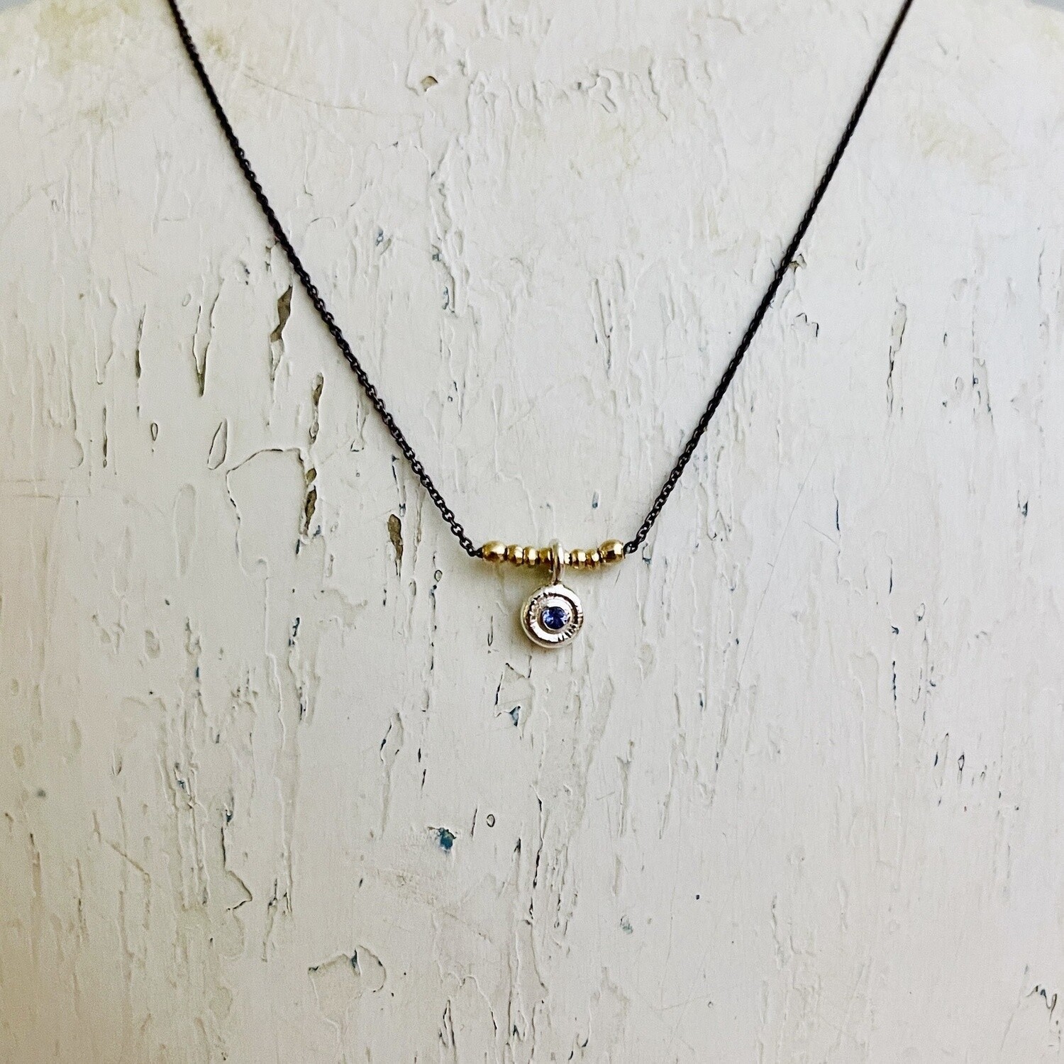 2mm Tanzanite set in textured sterling circle on oxidized sterling silver chain necklace