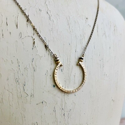 Textured 14kt gold filled horseshoe necklace on oxidized sterling chain