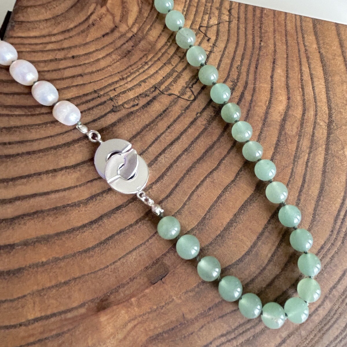 Handmade Silver Necklace with 1/2 white pearls. 1/2 aventurine knotted on green silk, interlocking c clasp