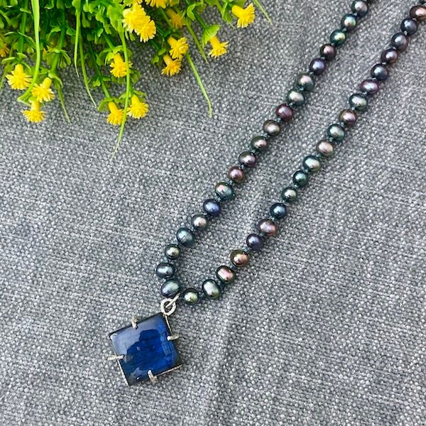 Handmade Necklace with peacock pearls knotted on blue silk with q prong set labradorite