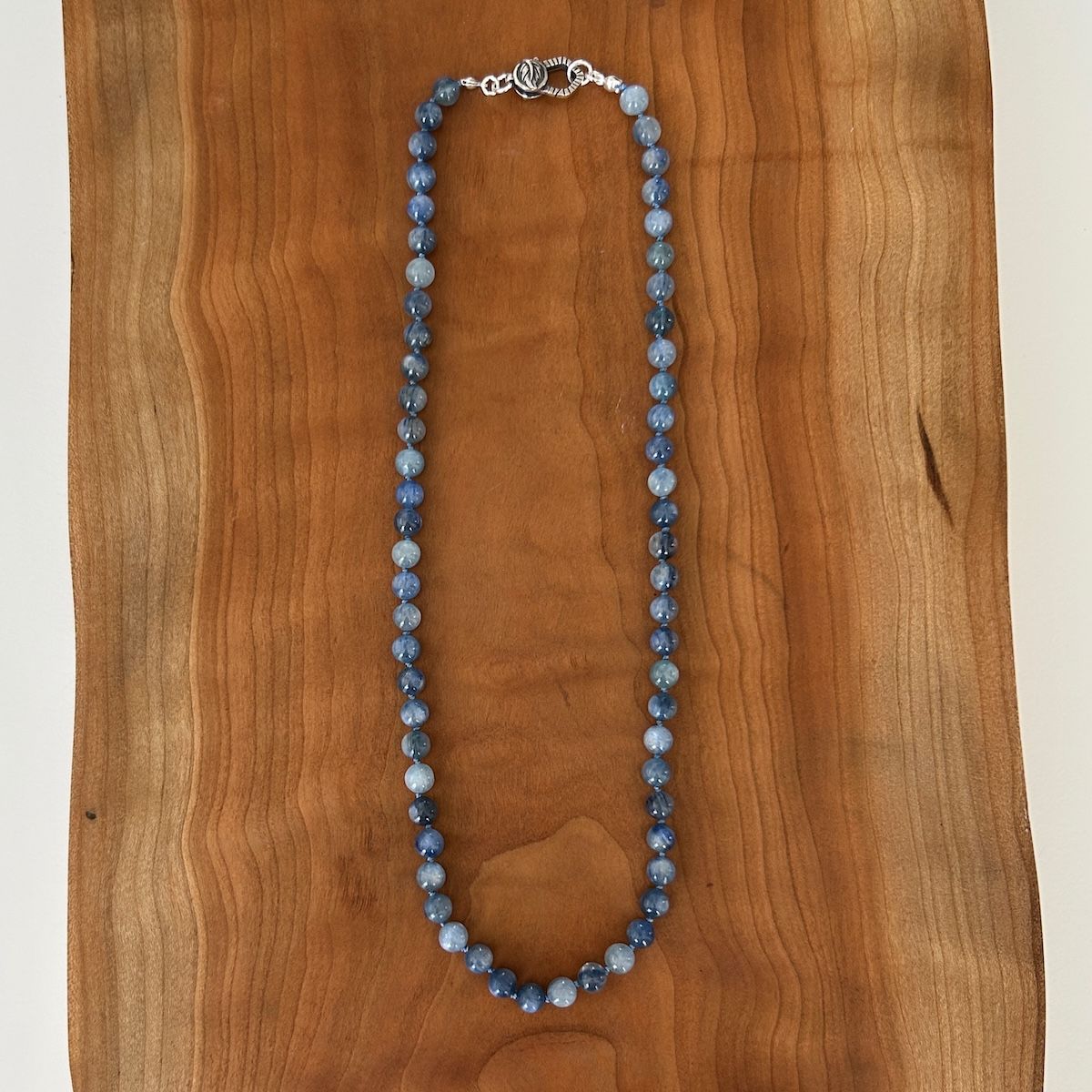 Handmade Necklace with kyanite knotted on hand dyed blue silk, leaf clasp