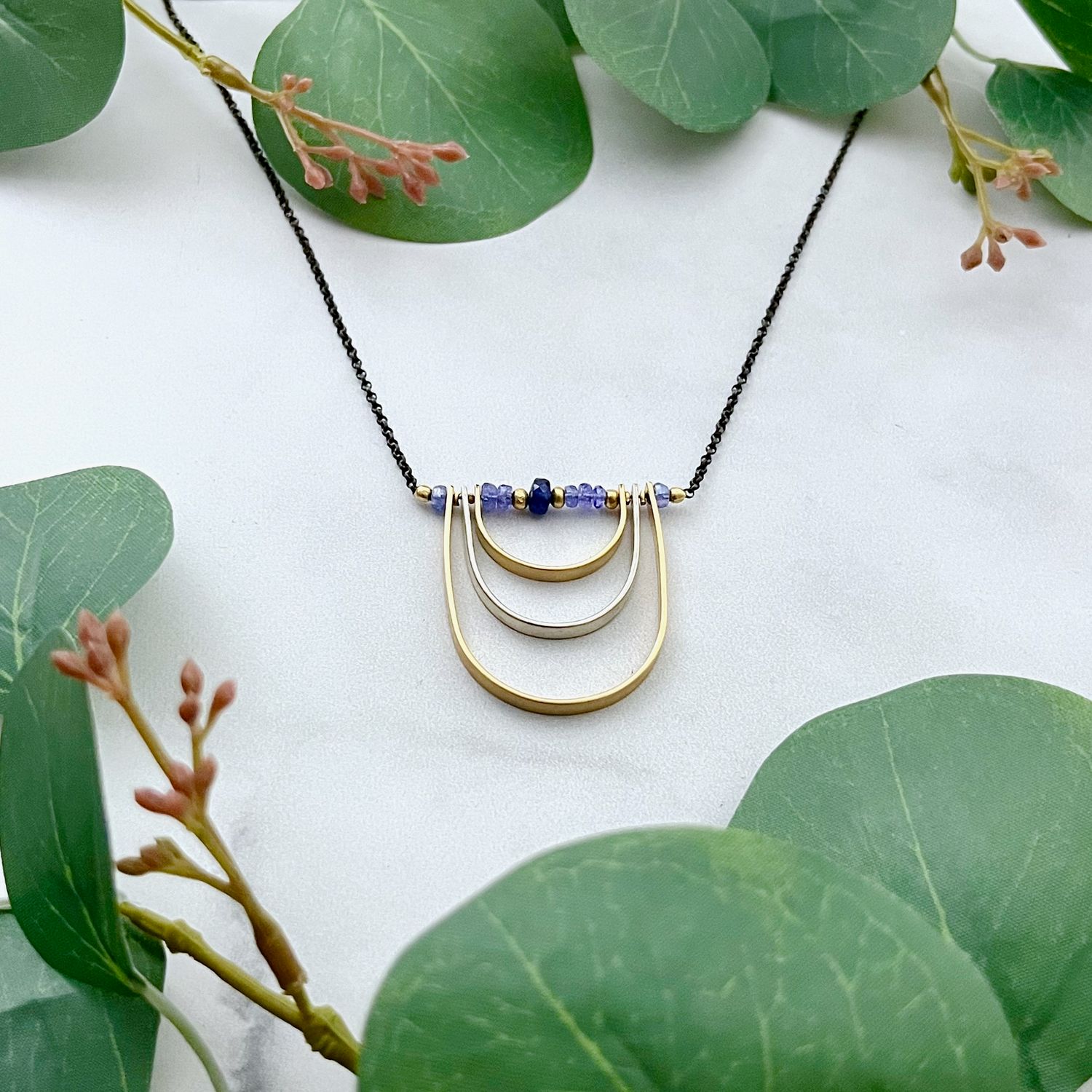Tanzanite, blue sapphire, mixed metals curve necklace, 18"