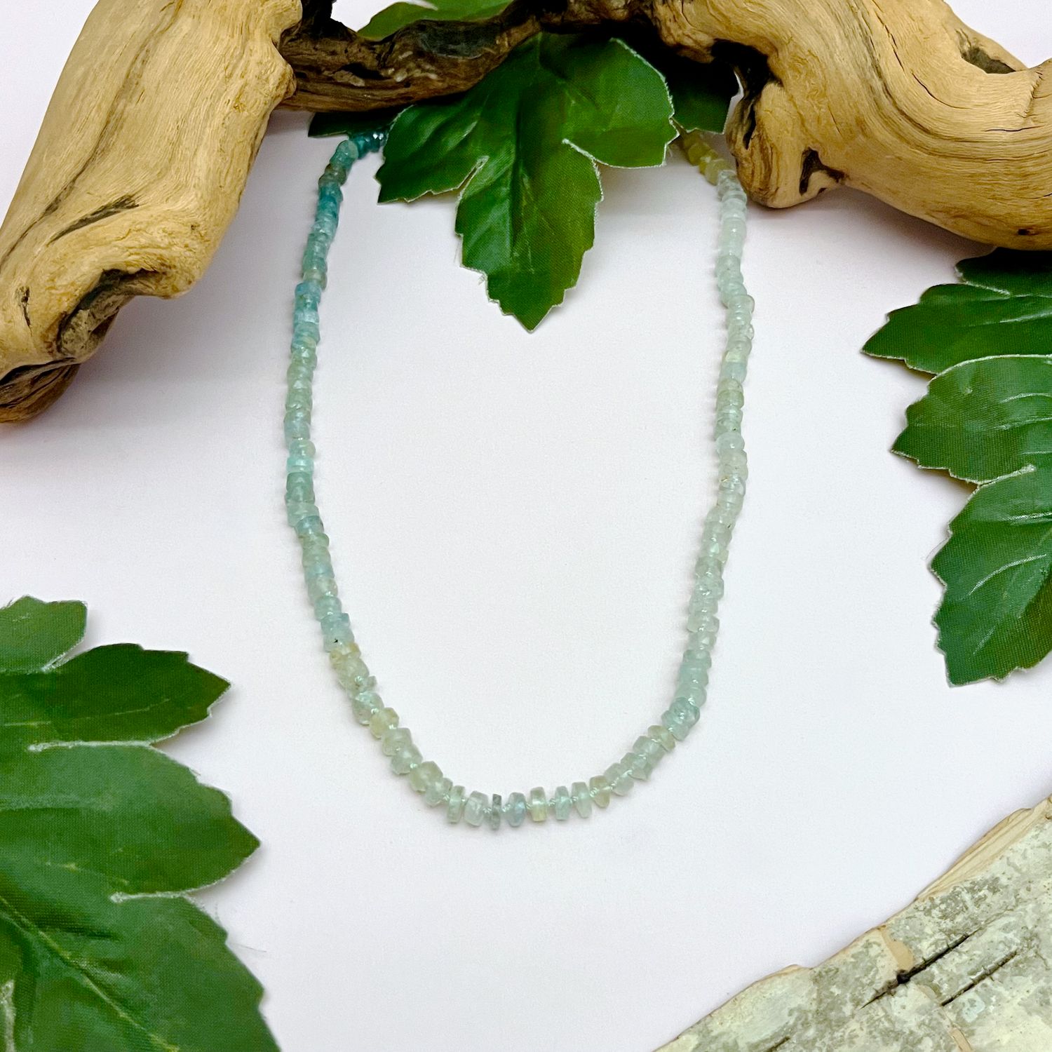 Handmade Necklace with graduated aquamarine knotted on hand dyed green silk