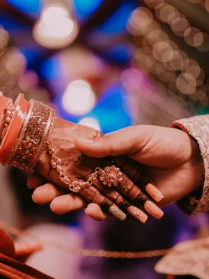 Elegant Indian wedding theme showcasing a bride and groom holding hands, symbolizing love and celebration, perfect for the Customized Return Gifts category at Human Birds International®, where personalized eco-friendly gifts like seed ball packs are crafted for memorable events.