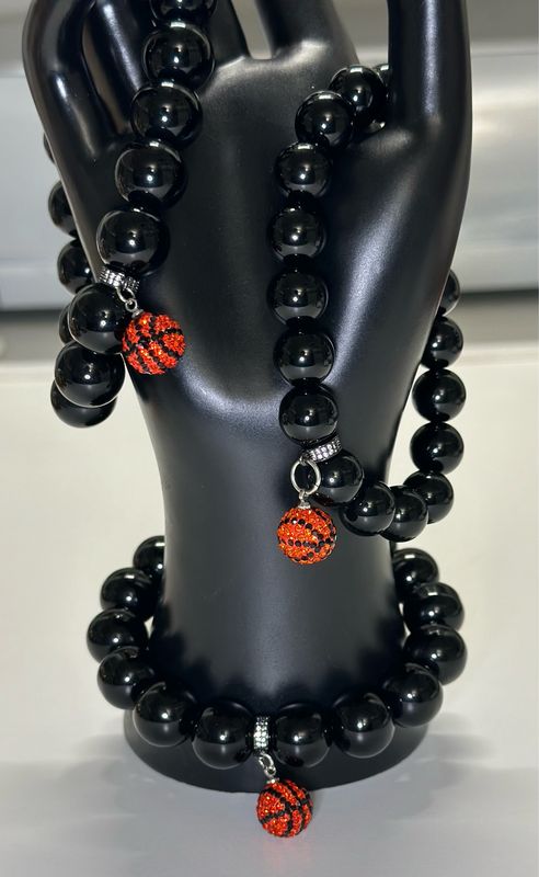 Add a touch of luxury and sportiness to your accessory collection with this striking Hoops &amp; Obsidian Power Bracelet.