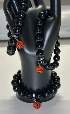 Add a touch of luxury and sportiness to your accessory collection with this striking Hoops &amp; Obsidian Power Bracelet.