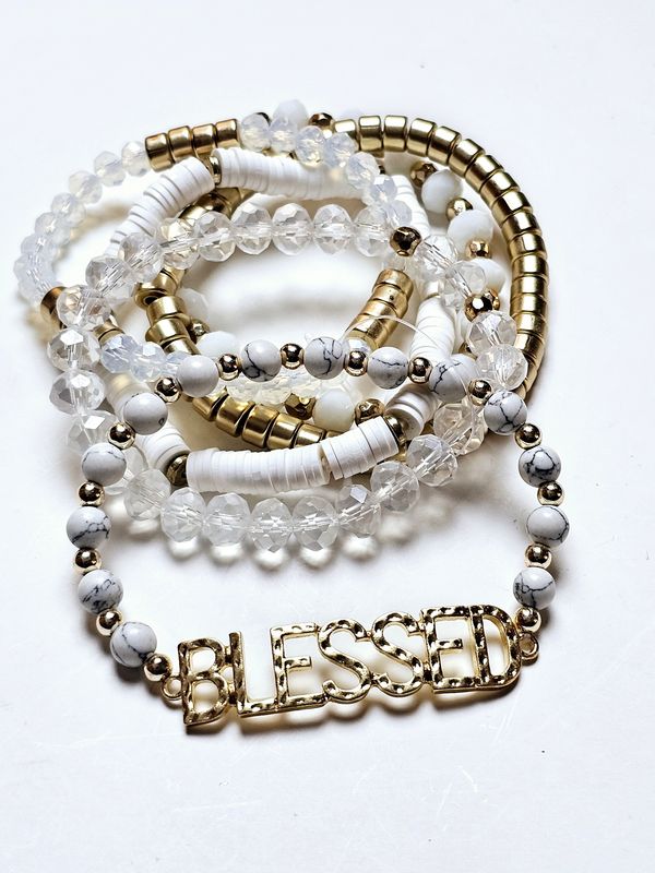 Radiant Harmony Bracelet Set, a stunning collection of bracelets featuring marbled white beads, clear faceted accents, and sleek gold details. The highlight of the set is a bold, gold-toned &quot;BLESSED&quot; charm, serving as both a fashionable statement and a reminder of gratitude and positivity. Perfect for stacking or wearing individually, these bracelets are versatile accessories that bring a touch of elegance and inspiration to any outfit.