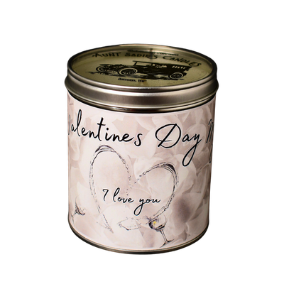 Valentine’s Day candle in a sleek metal tin with minimalist label featuring red roses, white wine imagery