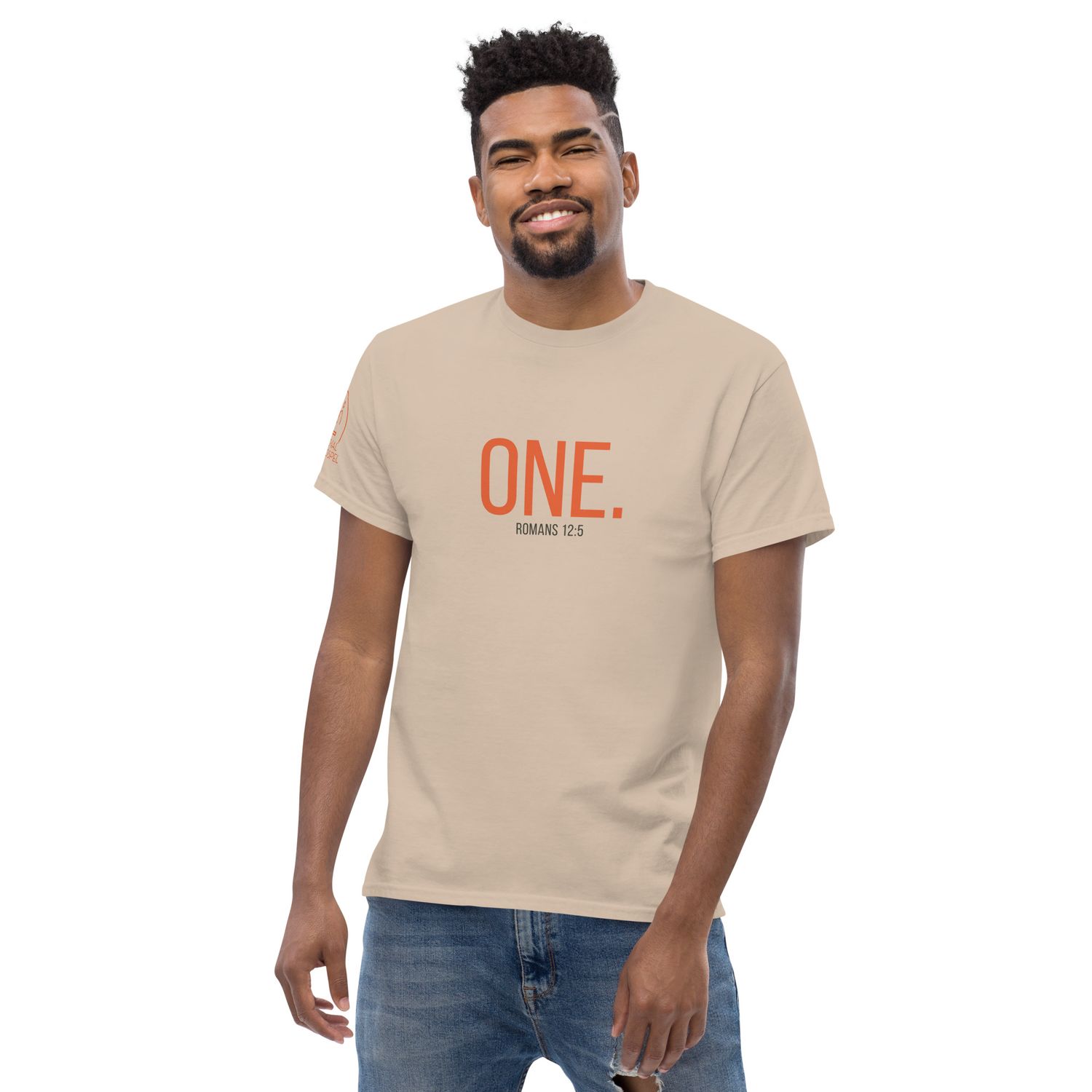 ONE. Romans 12:5 Cotton T-Shirt, Front View, Color: Sand