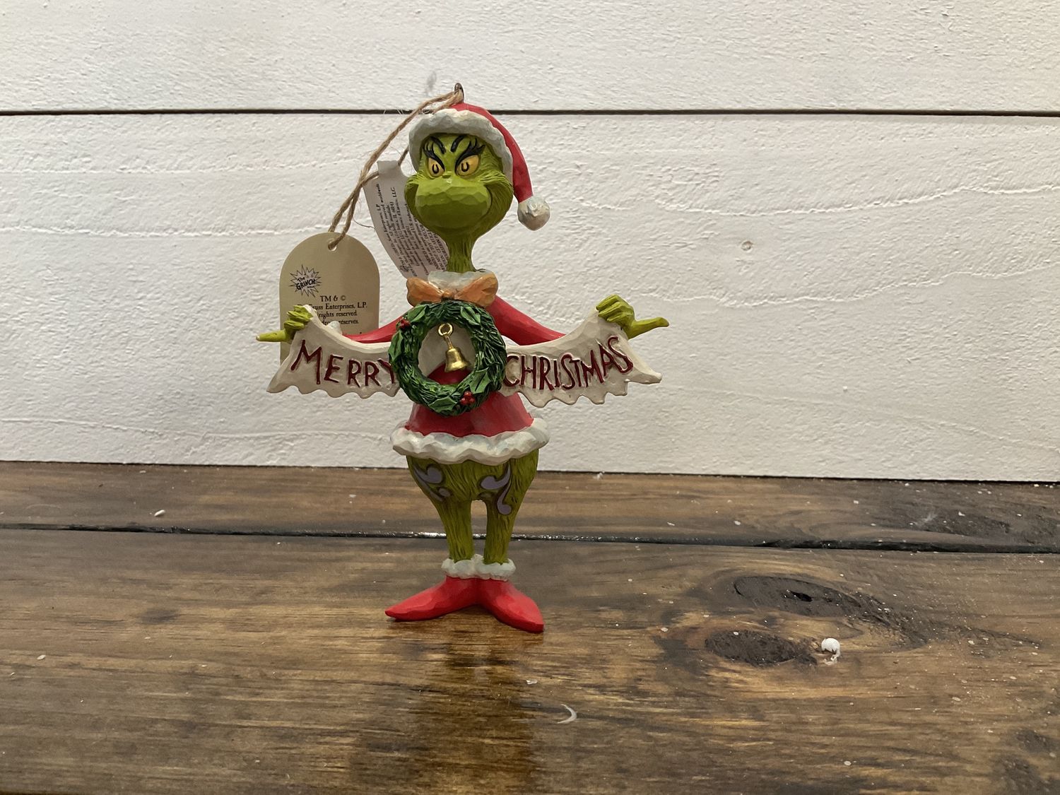 Grinch holding merry Christmas