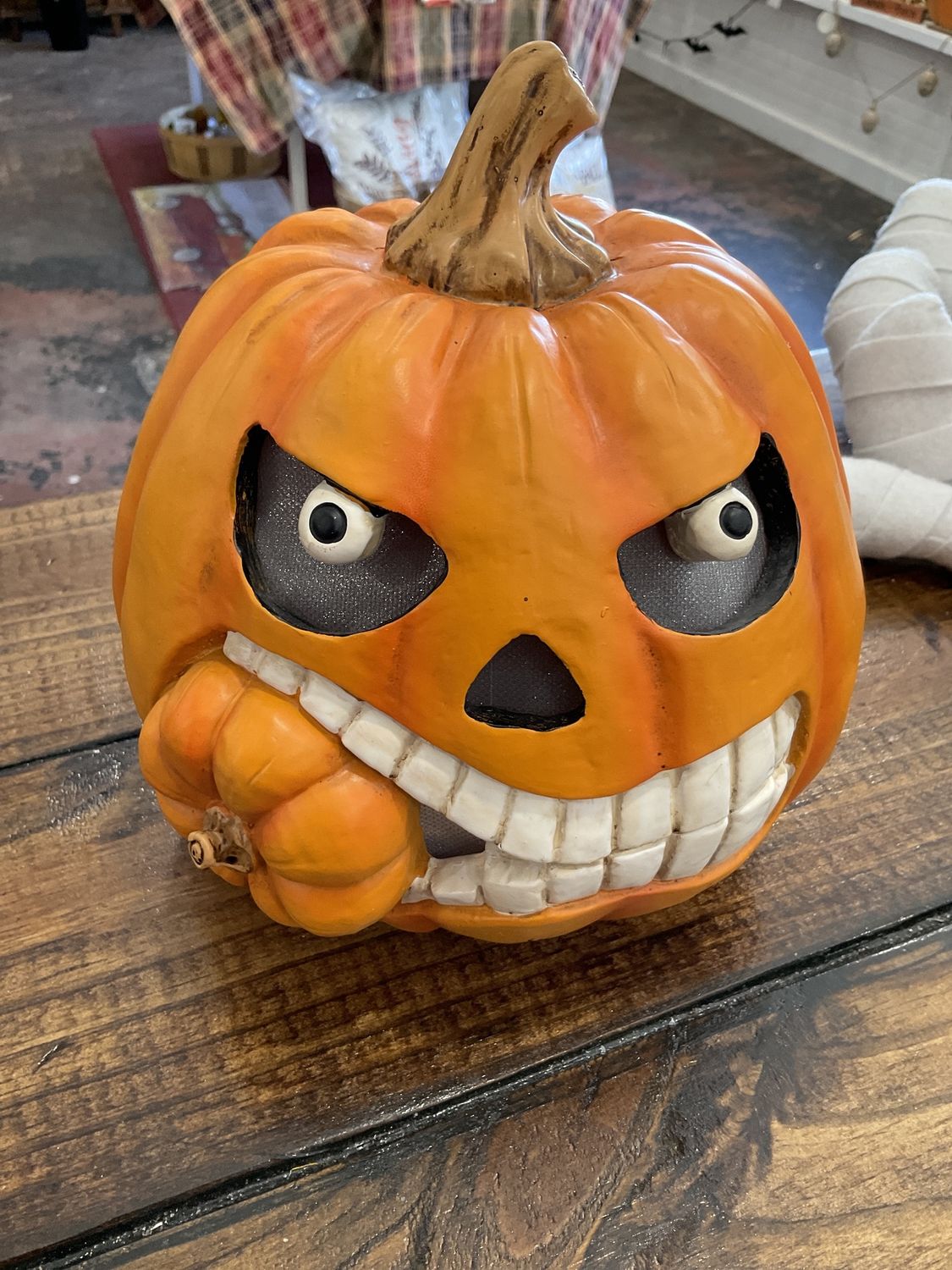 Lighted pumpkin face eating small pumpkin
