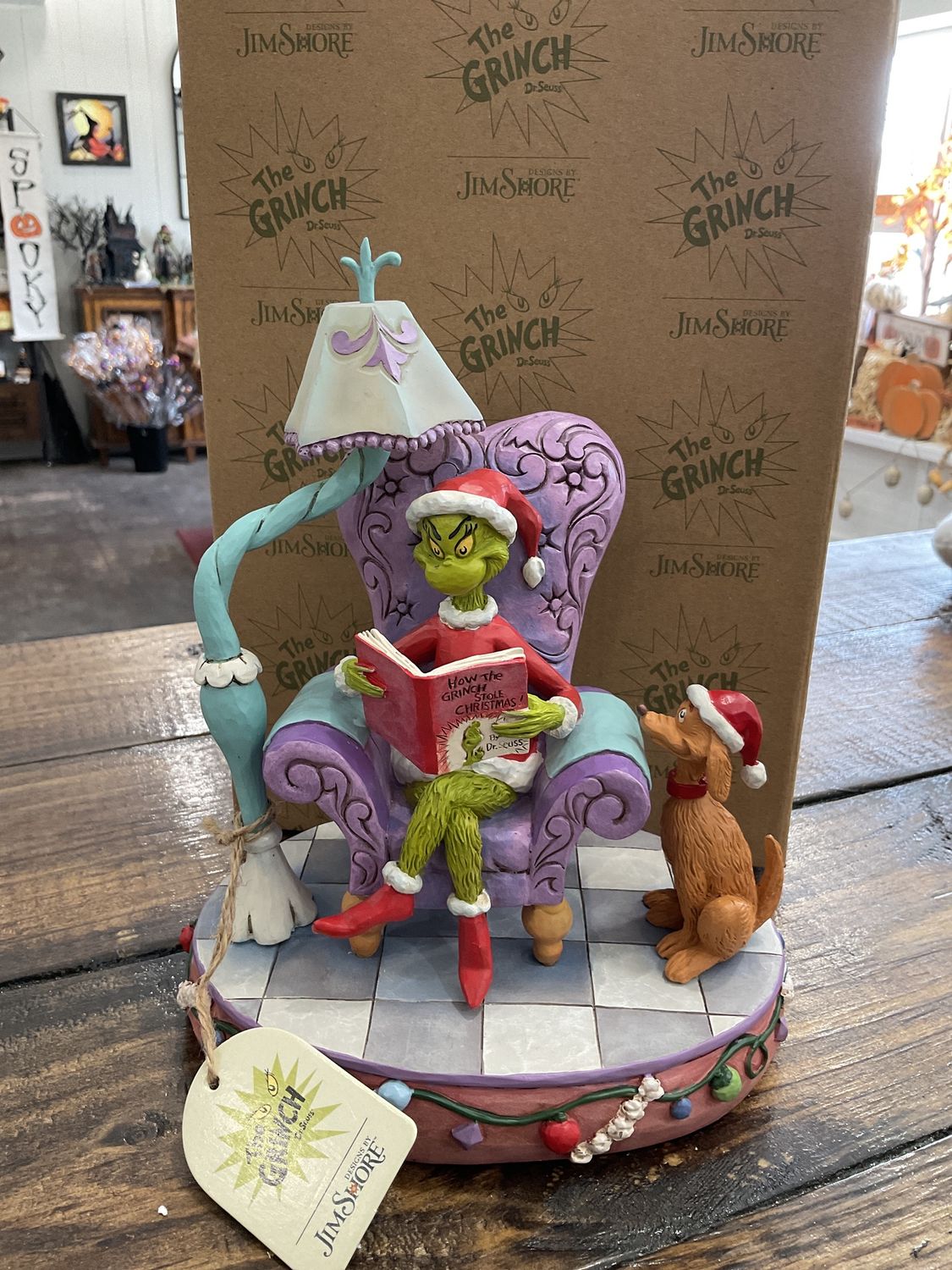 JS grinch in chair reading book