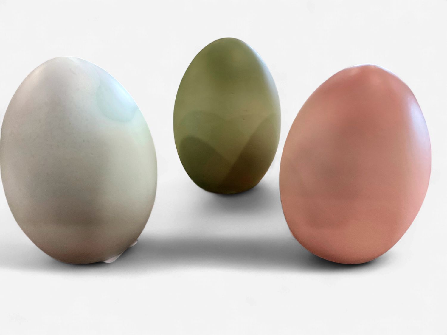 Three assorted large blue, green and pink resin eggs