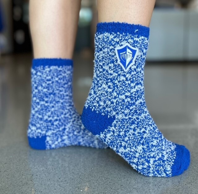 fuzzy socks that have white throughout them and features the Lynn spirit on logo the side. It comes in royal blue and gray.
