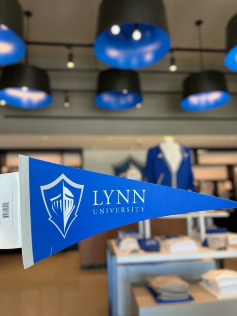 Royal blue felt pennant with the Lynn University logo and the spirit logo in white. 