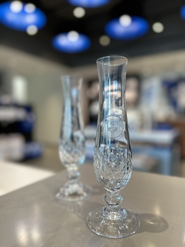 clear candlestick holder with clear Lynn logo on the front and design on the bottom.