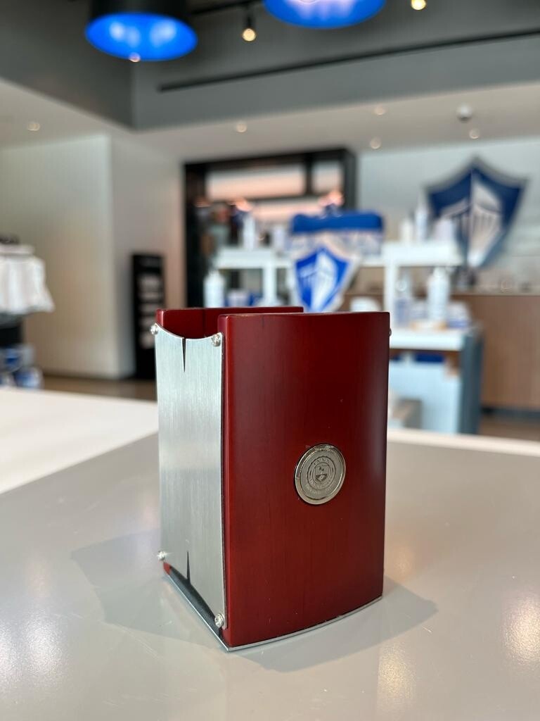 red and silver pencil caddy with Lynn logo in silver on the front.