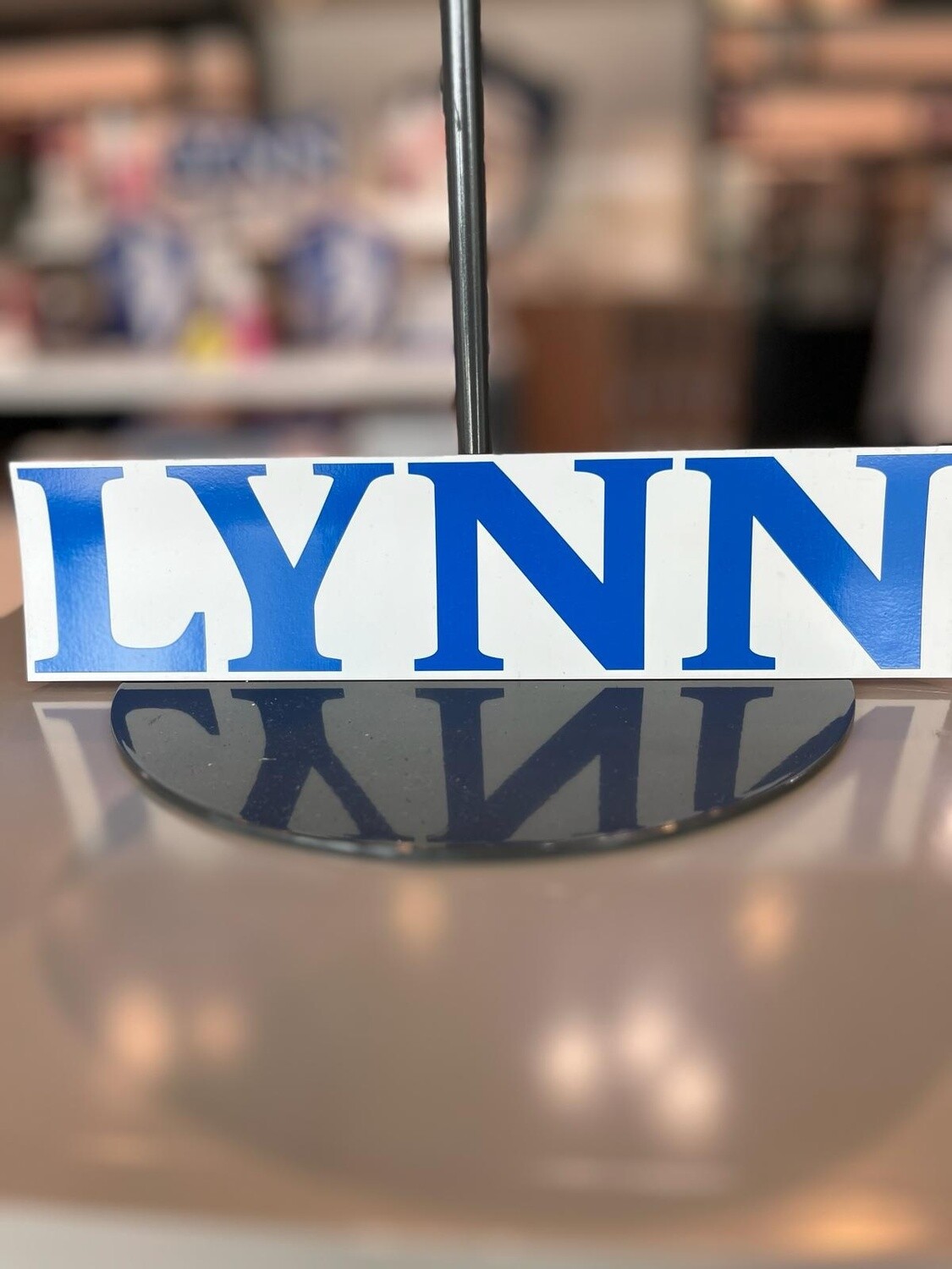 White Lynn magnet with blue text saying &quot;Lynn.&quot;
