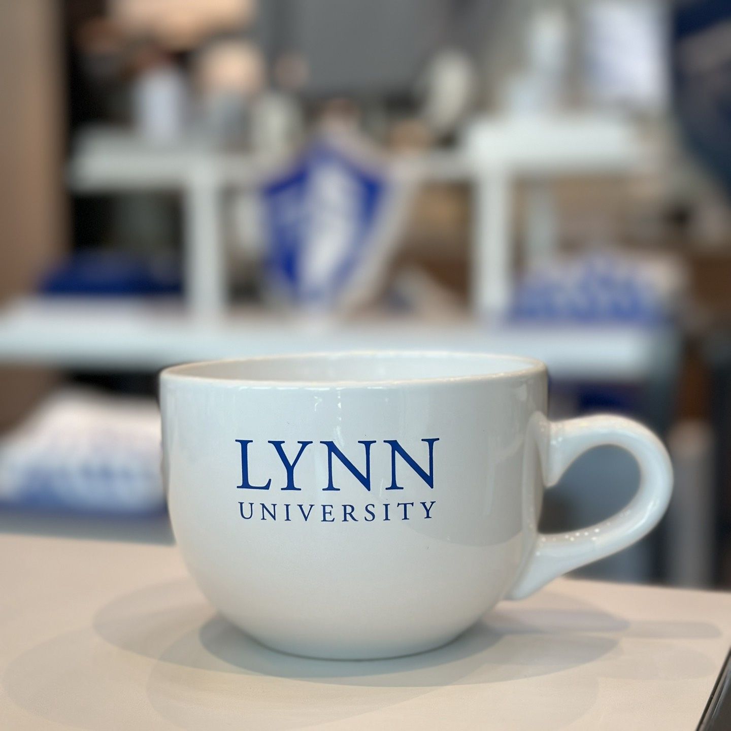 white oversized mug with blue text saying &quot;Lynn University.&quot;