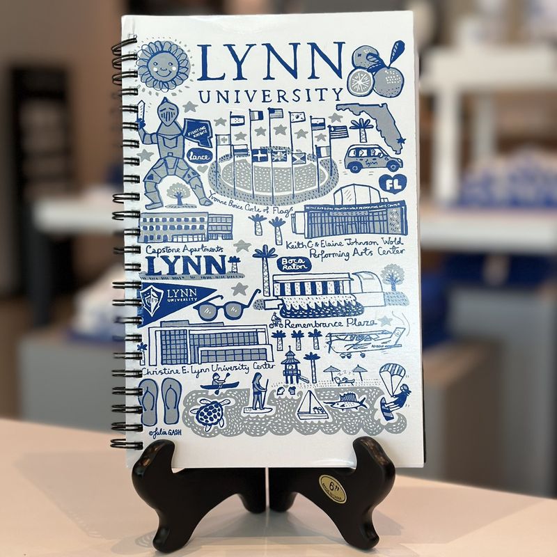 Journal with multiple royal blue Lynn logos on the front.