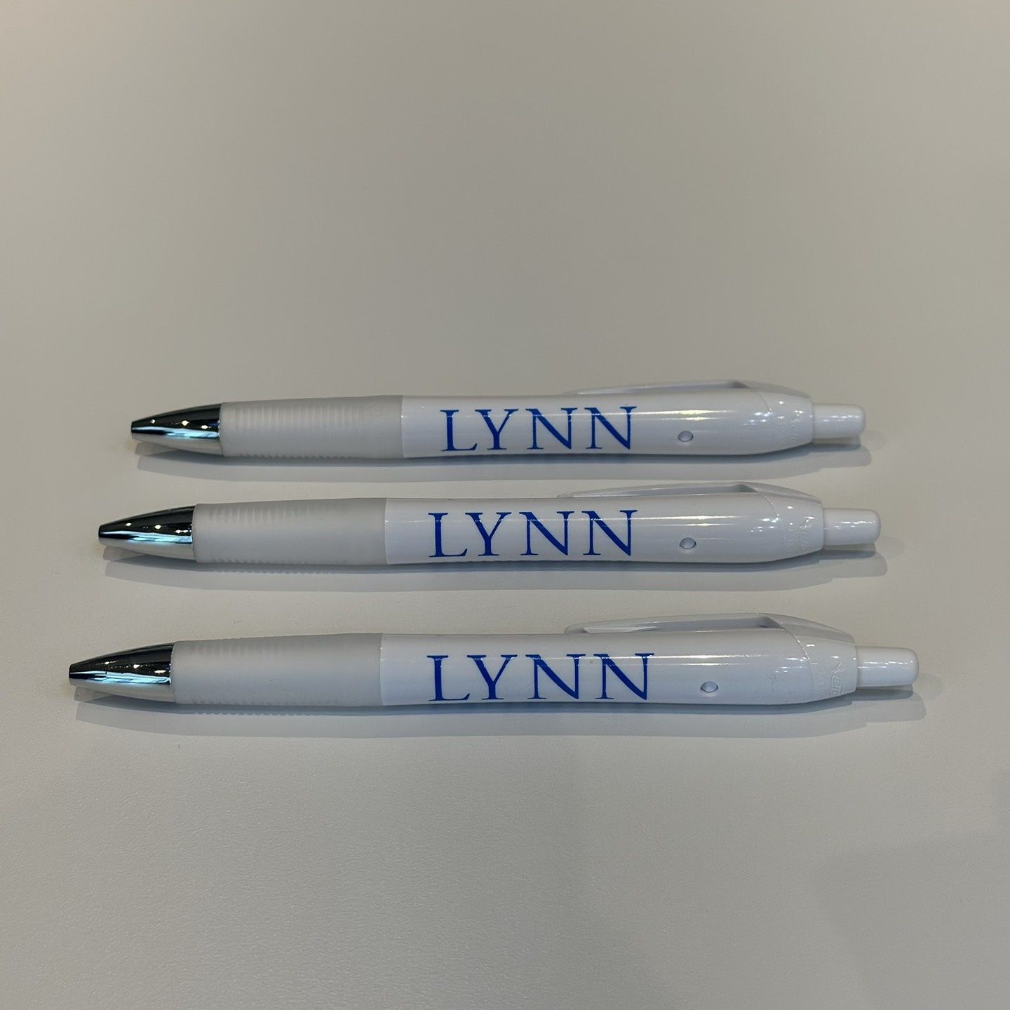 white and silver clickable pen with blue lettering saying &quot;Lynn.&quot;