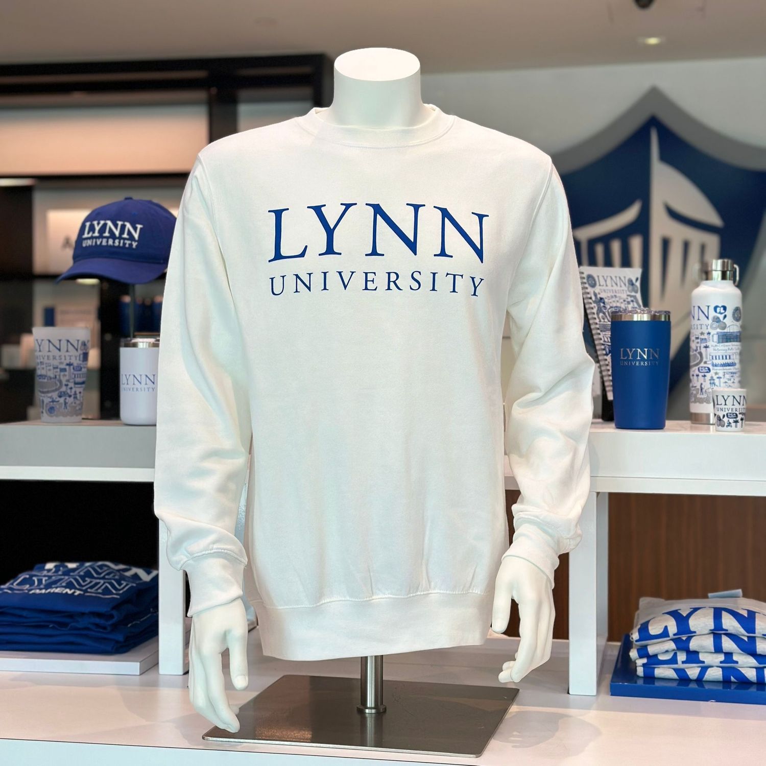 Fleece crewneck sweatshirt that comes in white, royal blue, and gray. 