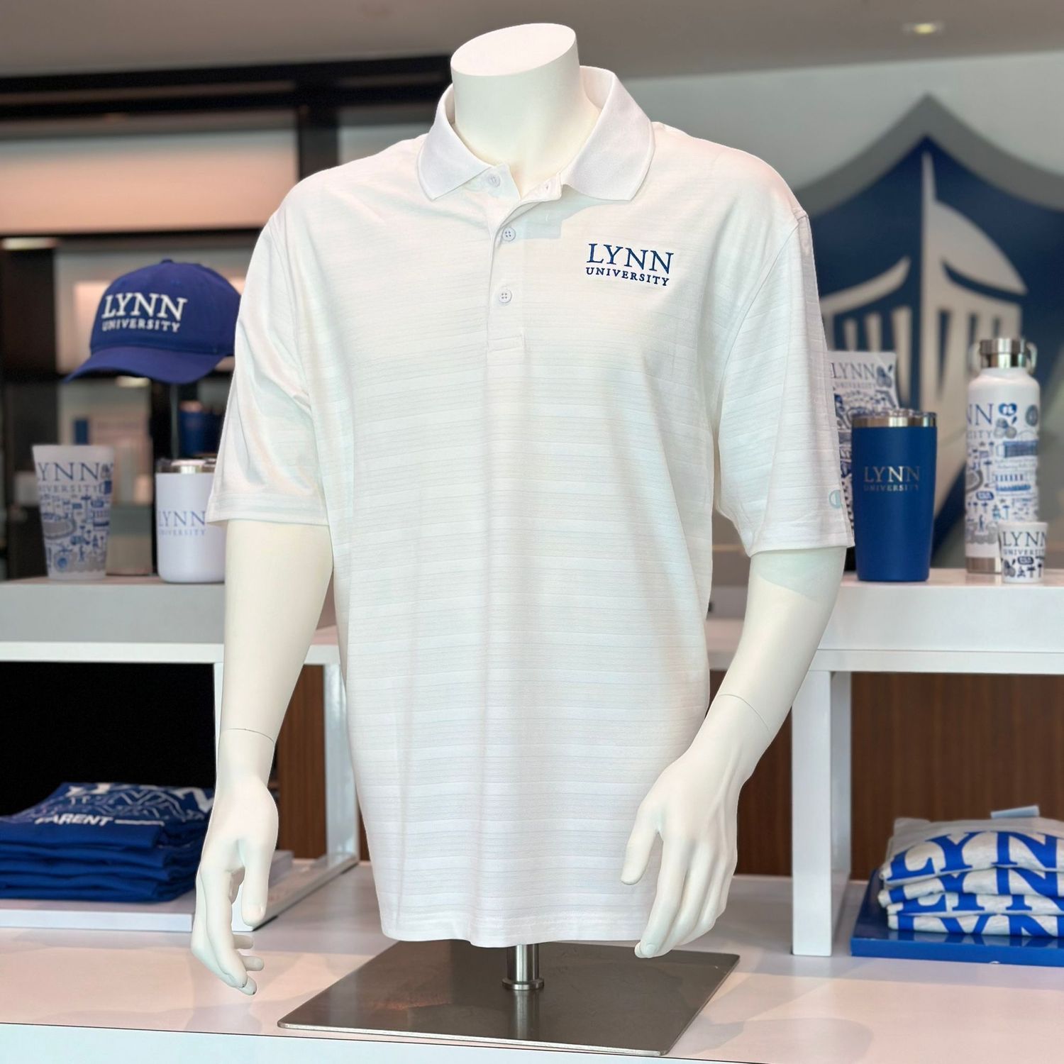 button up, short-sleeve polo that comes in royal blue and white. It has text on the left side of the chest saying &quot;Lynn University.&quot;