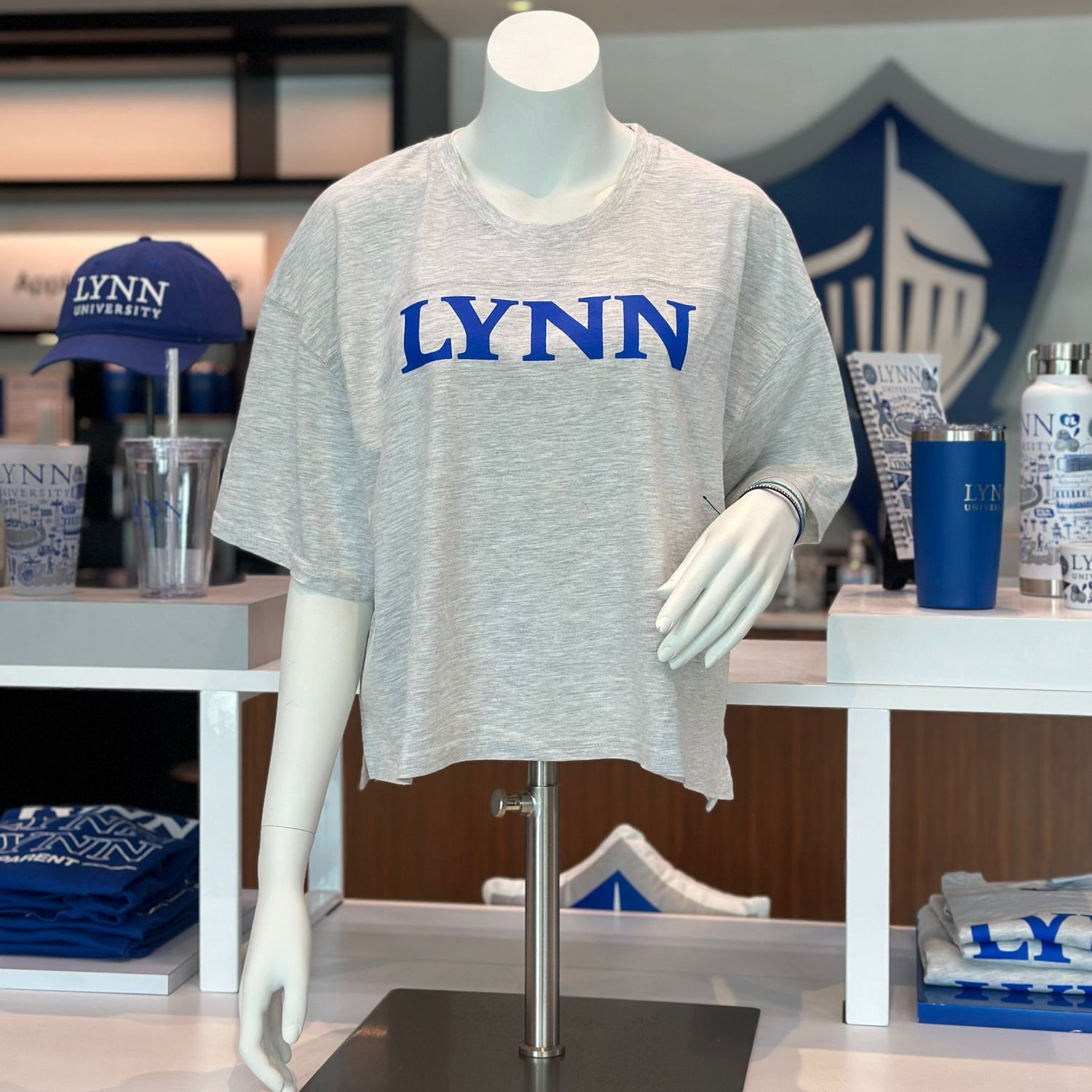 Gray short-sleeved cropped t-shirt, oversized, with royal blue text saying &quot;Lynn.&quot;