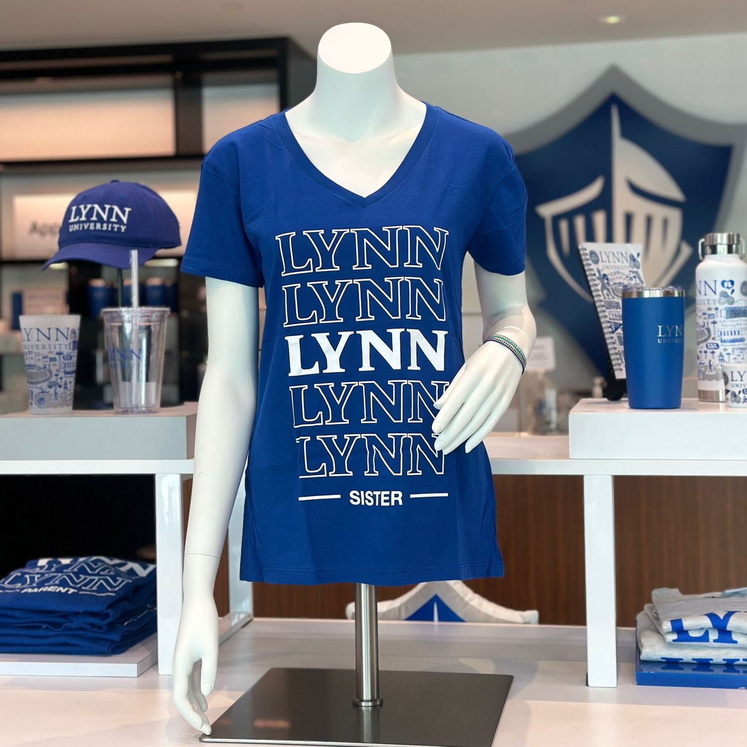 Choice between royal blue and white short-sleeve v-neck shirt and text saying &quot;Lynn Sister.&quot;