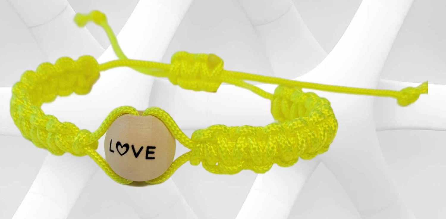 Set of 4 inspirational adjustable braided bracelets featuring wooden beads decorated with the words  ‘Love,’ ‘Blessed,’ ‘Hope,’ and ‘Faith.’