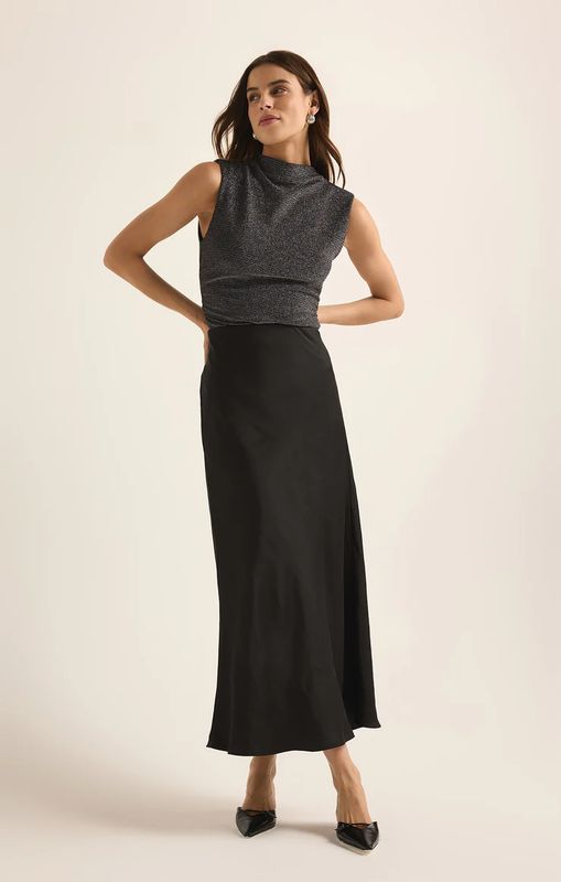 The Europa Poly Sheen Skirt by Z Supply is a chic and stylish skirt made from a smooth, polyester sheen fabric that gives it a subtle glossy finish. Designed with a high-waisted fit and a sleek, streamlined silhouette, it offers both comfort and elegance. 