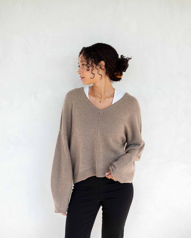 The Lugano Cashmere V-Neck Sweater by Mersea is a luxurious, high-quality sweater made from soft, breathable cashmere. It features a classic V-neck design, offering both comfort and elegance. 