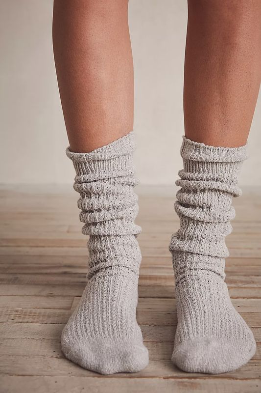 The Staple Slouch Socks by Free People are a cozy and stylish pair of socks designed for comfort and casual flair. Featuring a slouchy, relaxed fit, these socks are made from soft, breathable fabric and typically have a ribbed texture for added comfort. 