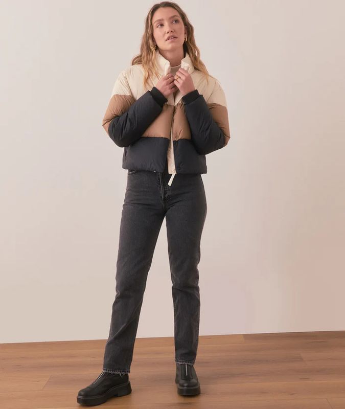 The Gia Crop Puffer Jacket from Marine Layer is a trendy, cropped outerwear piece designed for warmth and style. It features a short, boxy cut that pairs well with high-waisted pants or skirts.