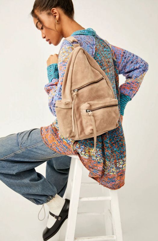 The Oxford Suede Sling Bag by Free People is a sleek and stylish crossbody bag made from soft, high-quality suede.
