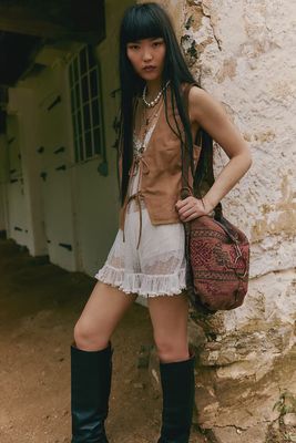 The Talia Bag by Free People is a stylish and functional accessory designed with a bohemian flair. It features a spacious main compartment with a soft, structured shape, offering plenty of room for daily essentials. 