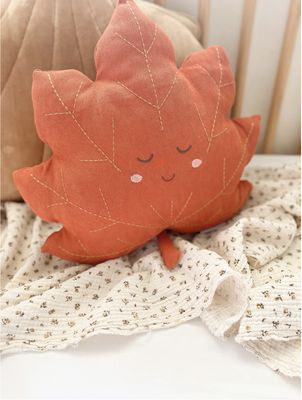 The Mon Ami Maple Leaf Accent Decor Plush is a charming, seasonal decorative plush designed to resemble a vibrant orange maple leaf.