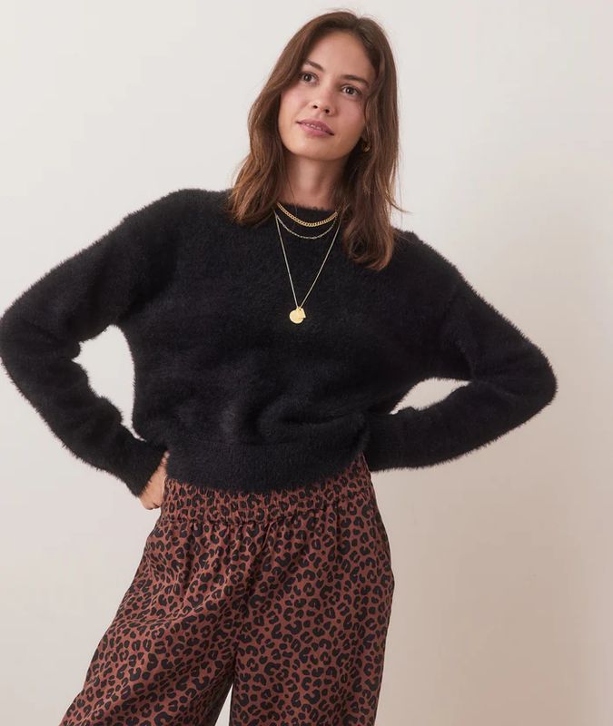 The Eyelash Cropped Crewneck Sweater is a soft, cozy sweater featuring a cropped length and a crewneck design. 